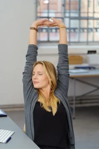 Person taking a mindful pause at a desk